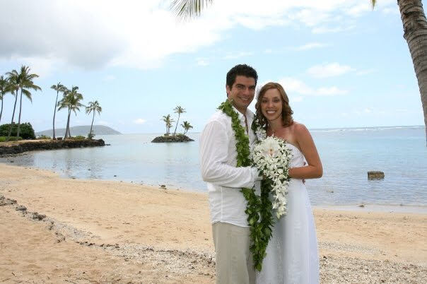 A young couple getting married on the sand at Waiʻalae Beach Park. 