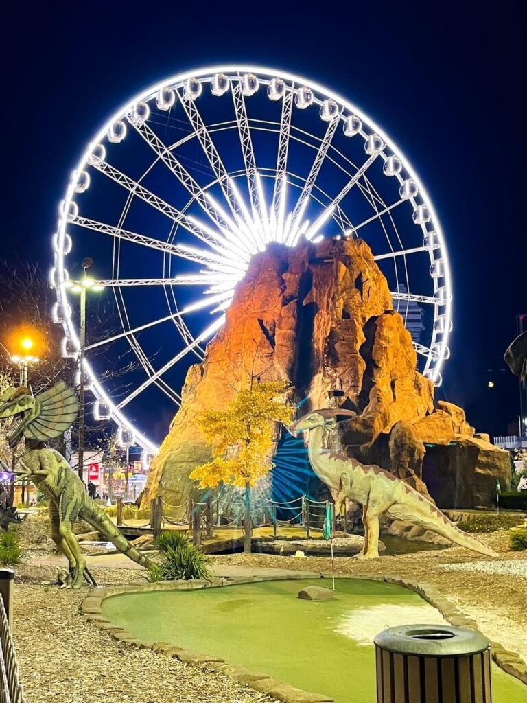 Niagara Falls Dino Golf with the Skywheel in the background lit up at night.