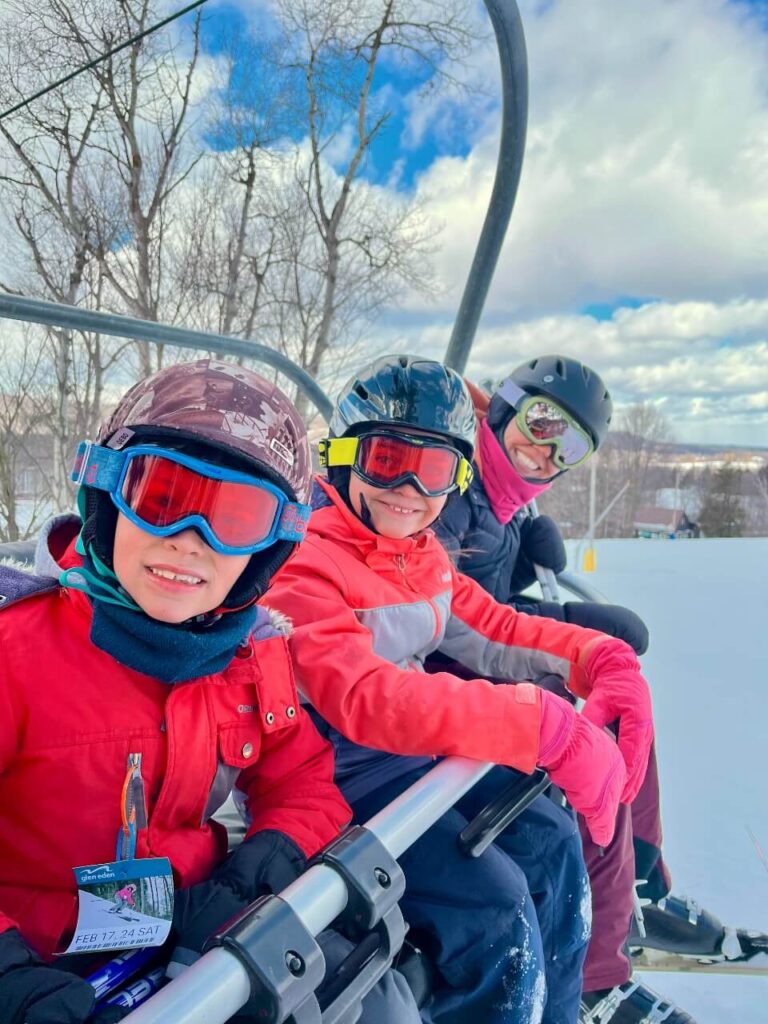 mom and two kids on the ski lift