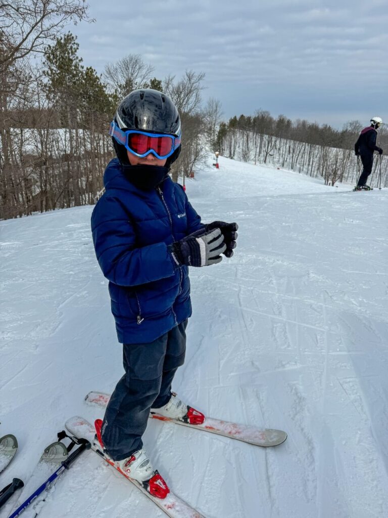 A young boy, ready for skiing with all the gear on