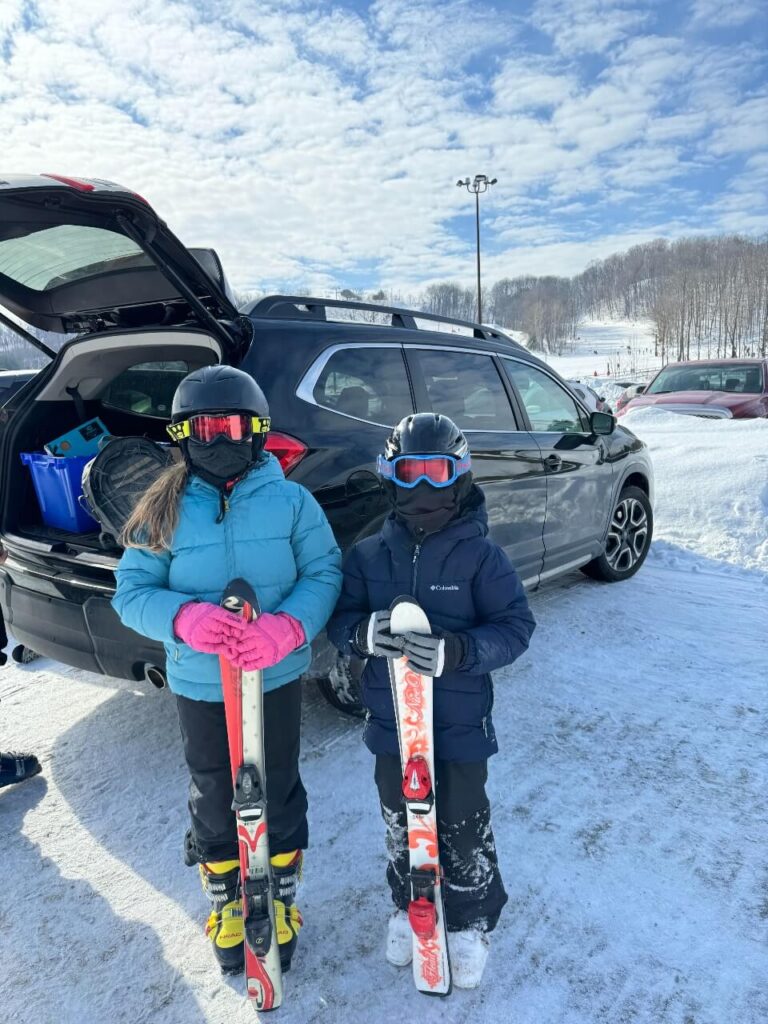 Getting the ski gear out of the car, 2 kids ready to go