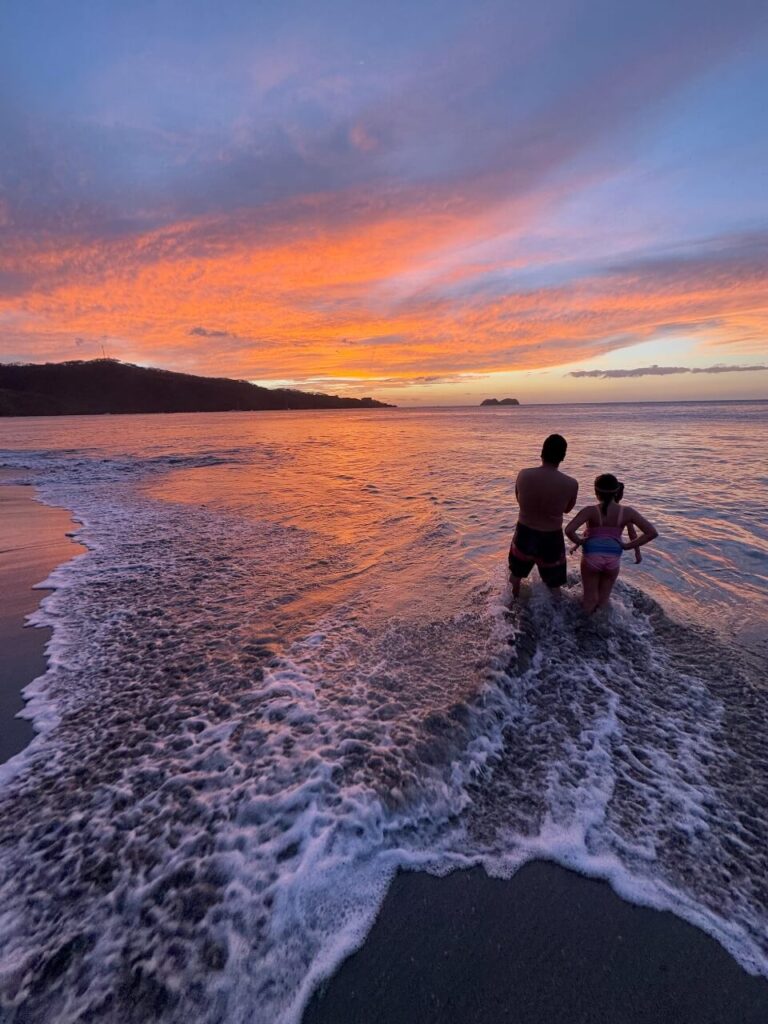 Beautiful beach sunset with purple, orange yellow and red colours in the sky