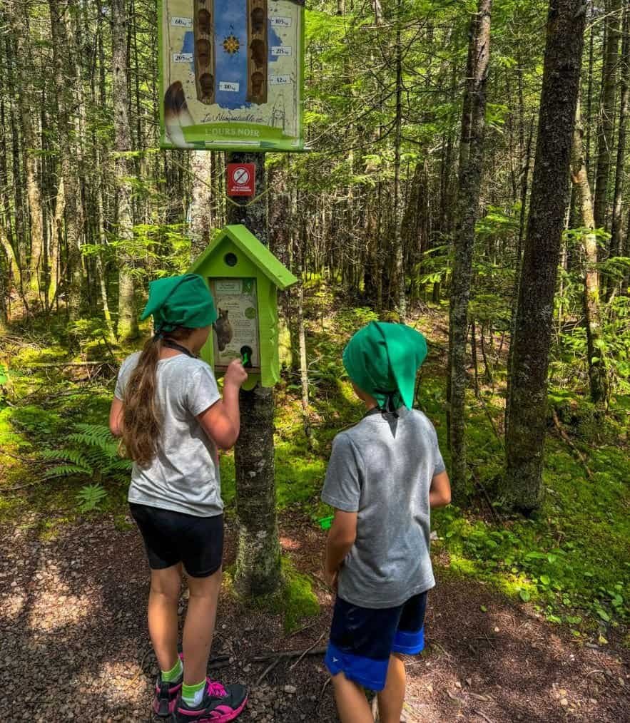 girl and boy opening secret boxes in the Gnome Hunt at The Secret Valley wearing gnome hats