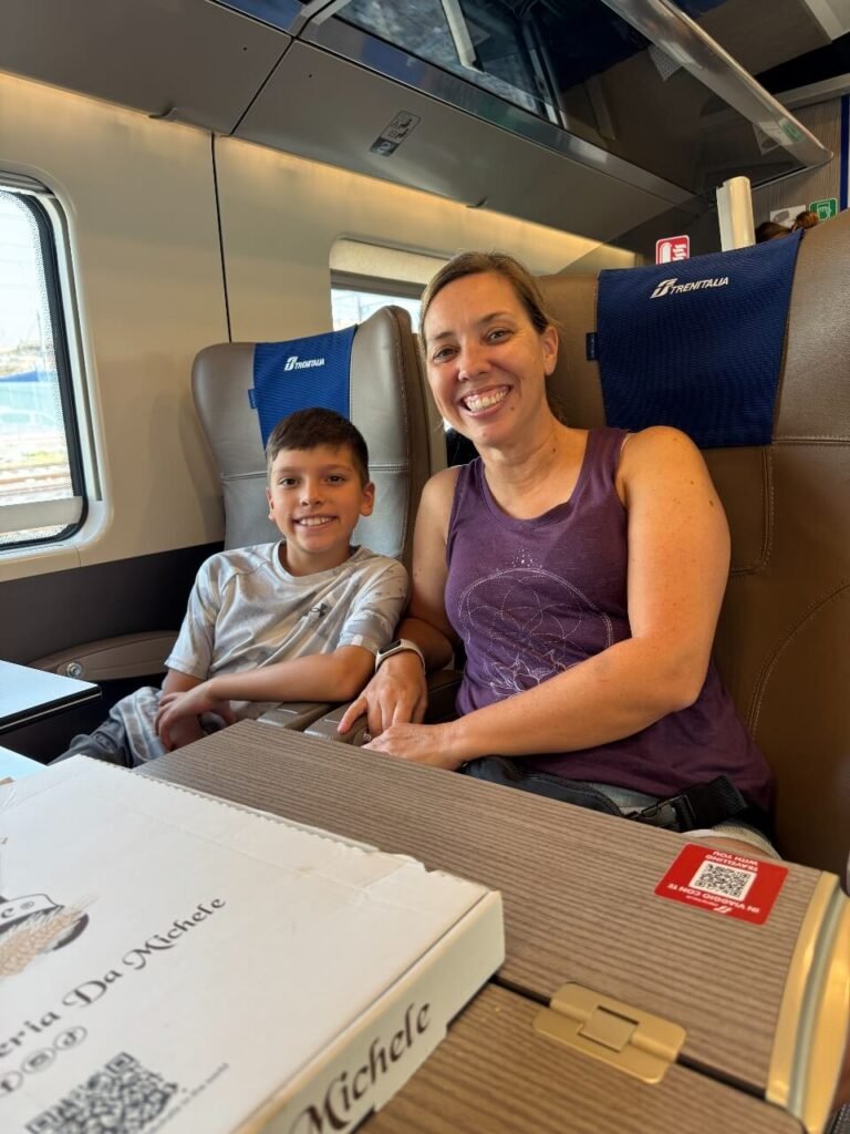 mother and son sitting on the train in italy